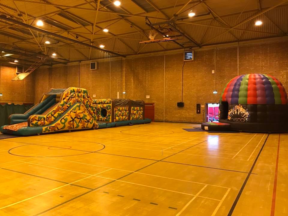 This image shows one of our disco party pods and inflatable assault courses on hire in St Helens