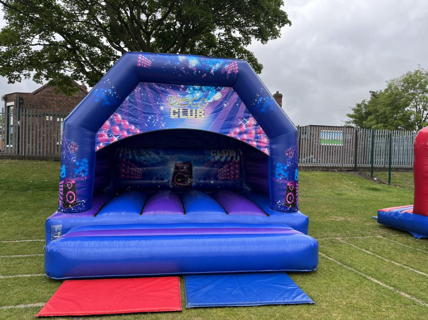 This image shows an SJ's Leisure disco bouncy castle inflatable on hire in the Warrington region. Available to book online through interactive booking software.
