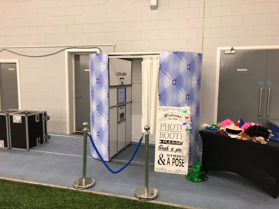 This image shows a photobooth designed with a blue Chesterfield sofa style skin at the Everton FC Christmas party This image shows a blue Chesterfield style photobooth on hire from SJ's Leisure