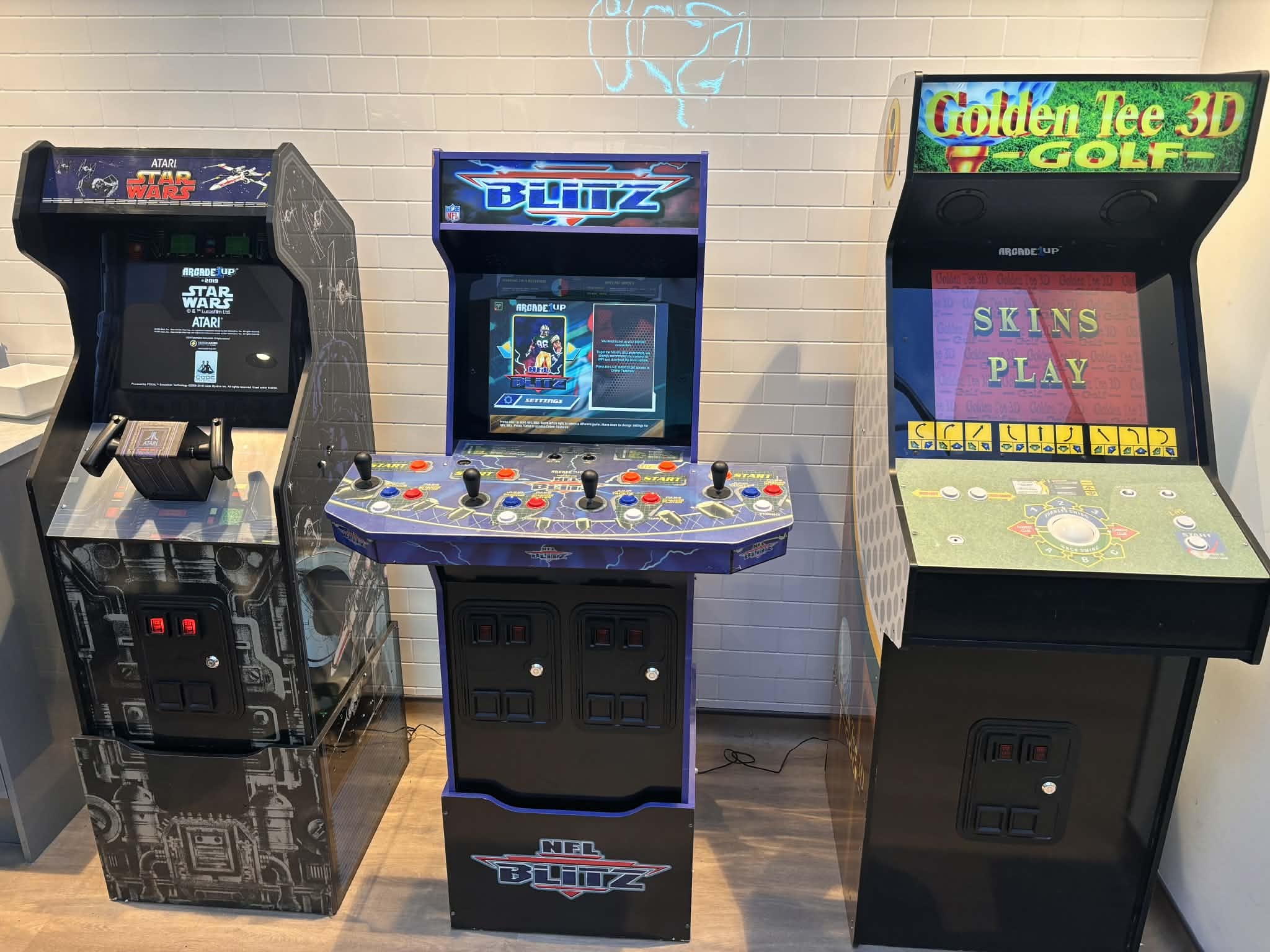 An image of three arcade machines set up at Walkers Snack Foods in Skelmersdale for a staff wellbeing event