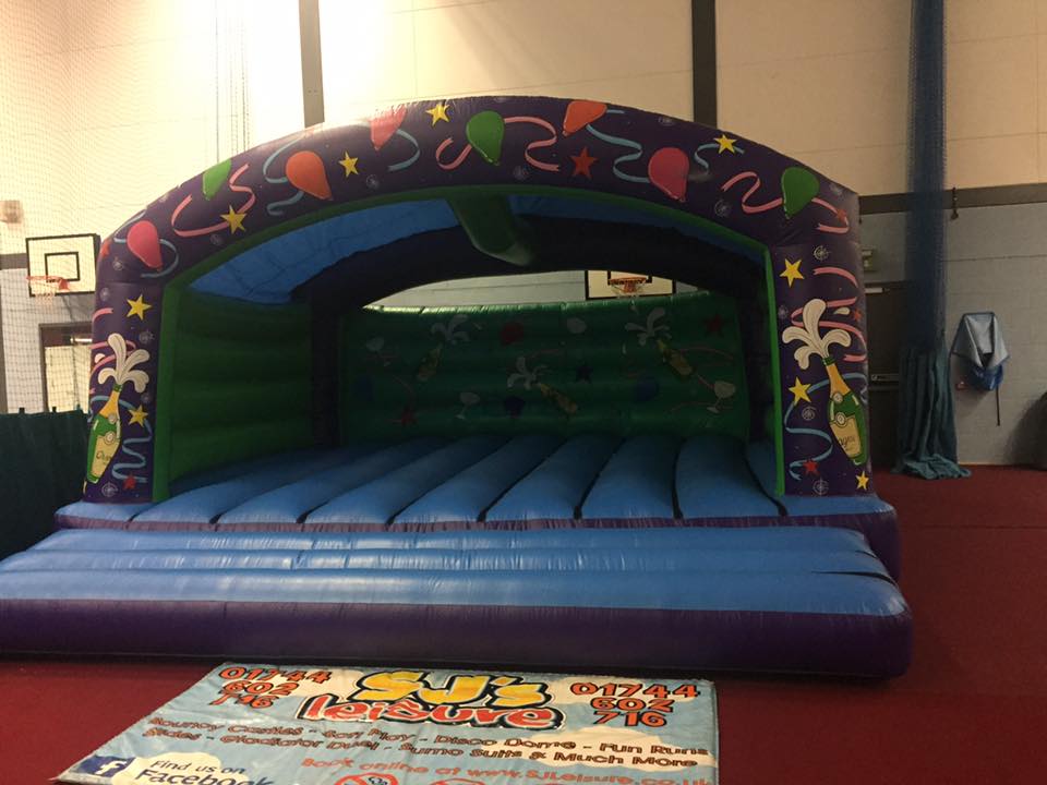 This image shows a large bouncy castle on hire at a youth centre in Wigan Bouncy Castle Hire Wigan