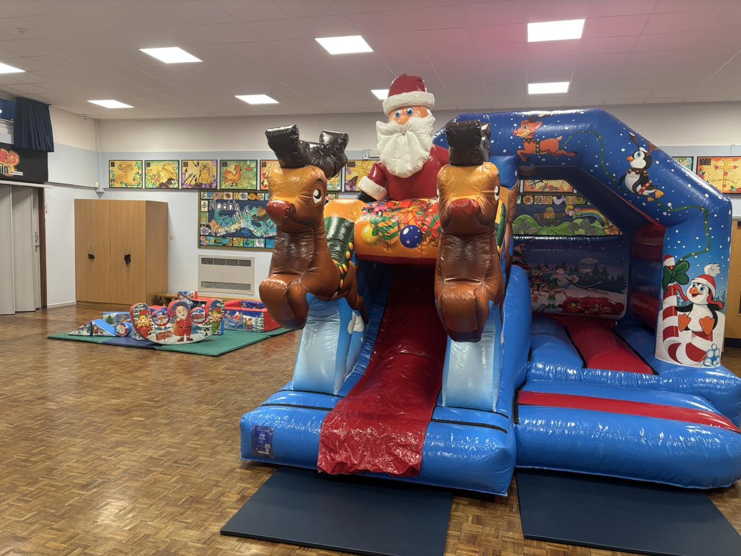 Christmas front slide bouncy castle combo and Christmas soft play set up at a primary school in Runcorn