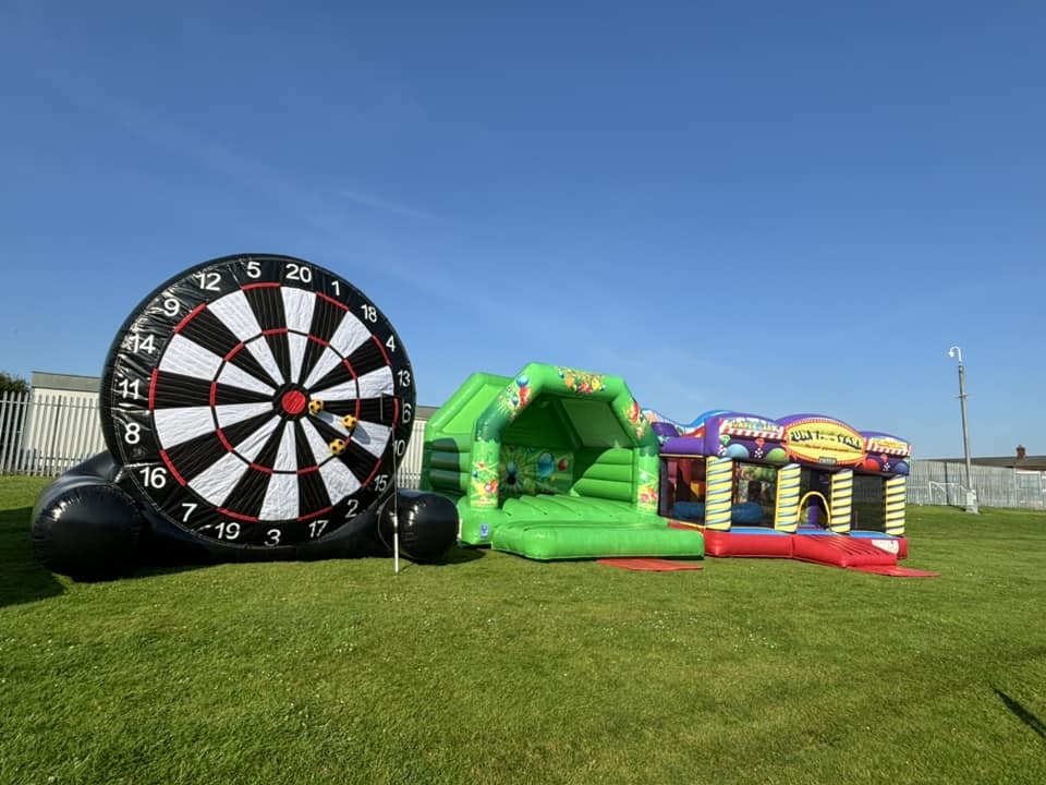 Inflatable midi football dartboard, large bouncy castle and fun fair inflatable set up in St Helens for a primary school summer fun day.