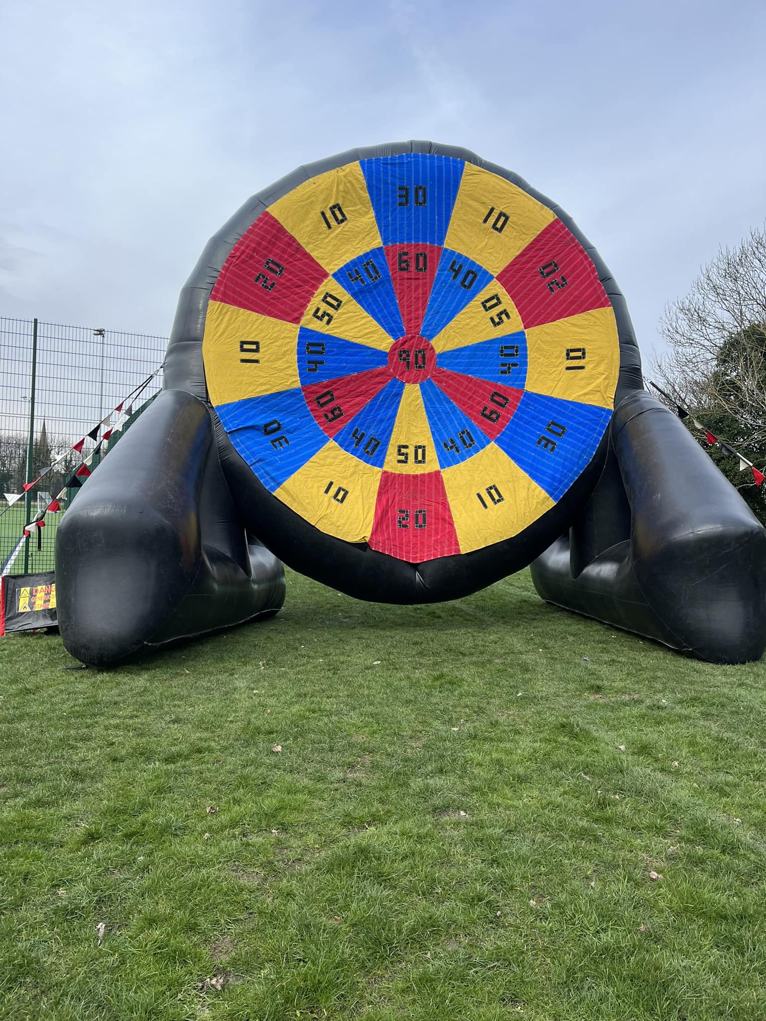 This image shows an inflatable football darts challenge at an event organised by Liverpool FC.