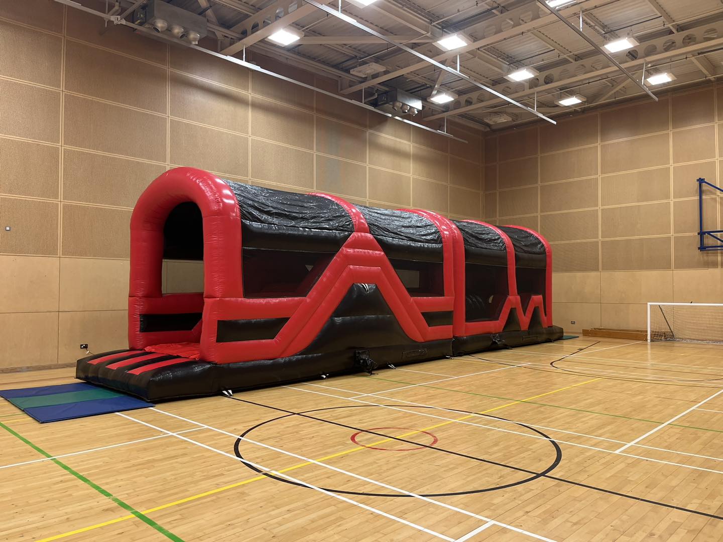 Inflatable obstacle course set up in a school hall due to inclement weather