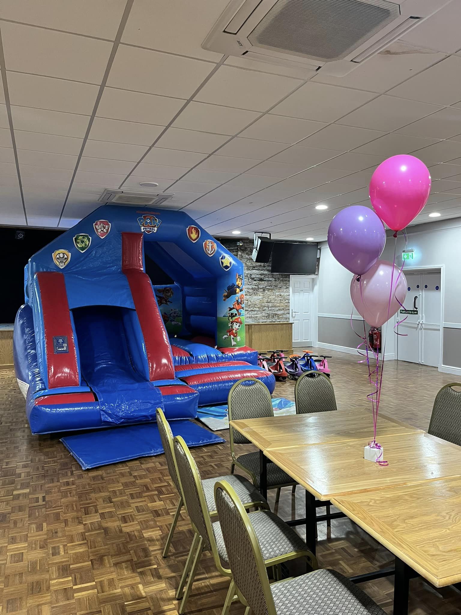 A Paw Patrol themed bouncy castle and slide combo