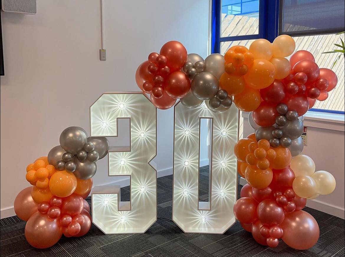 This image shows a balloon display and LED 30 sign on hire at QVC UK