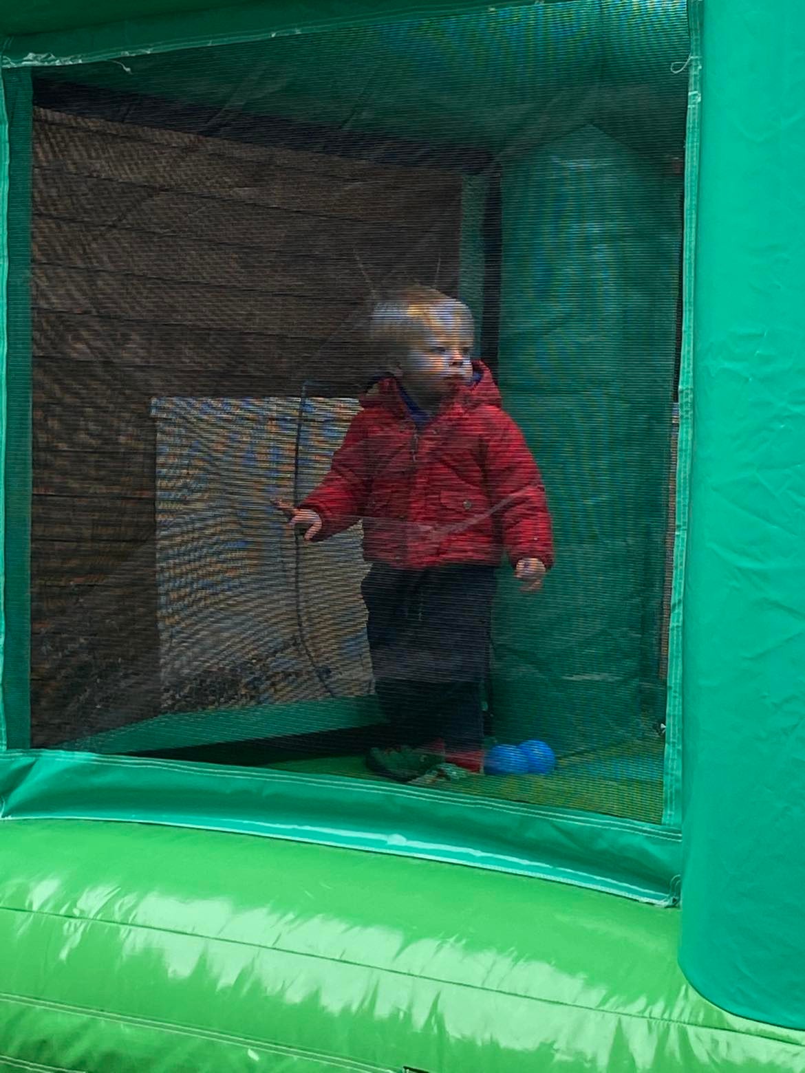 An image of my son, Teddy, using a small bouncy castle at home at 3 years old.