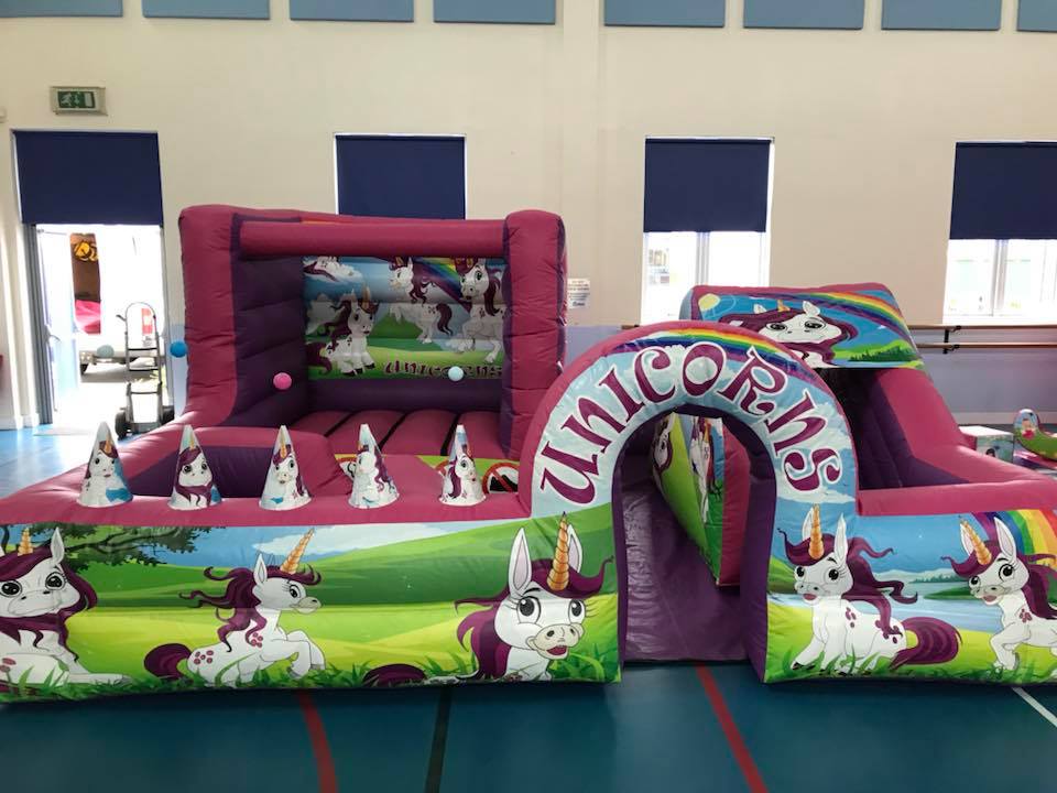 This image shows an inflatable unicorn play park on hire in Chorley
